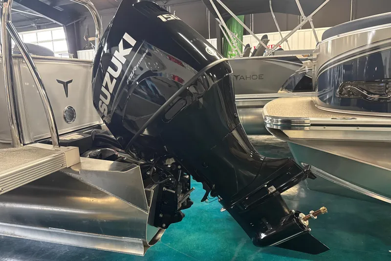 Slide: The Image of 2026 Tahoe Pontoon LTZ Quad Lounger with Suzuki outboard motor in showroom. - 4
