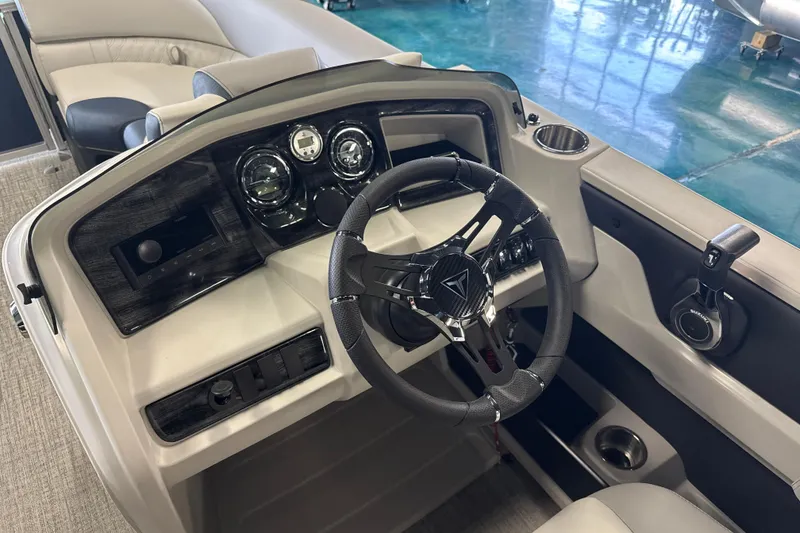 Slide: The Image of 2026 Tahoe Pontoon LTZ Quad Lounger dashboard with steering wheel and controls. - 6