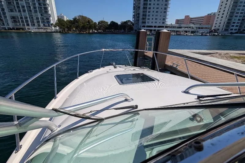 Slide: The Image of 2014 Robalo R305 Walkaround boat docked near waterfront buildings. - 19