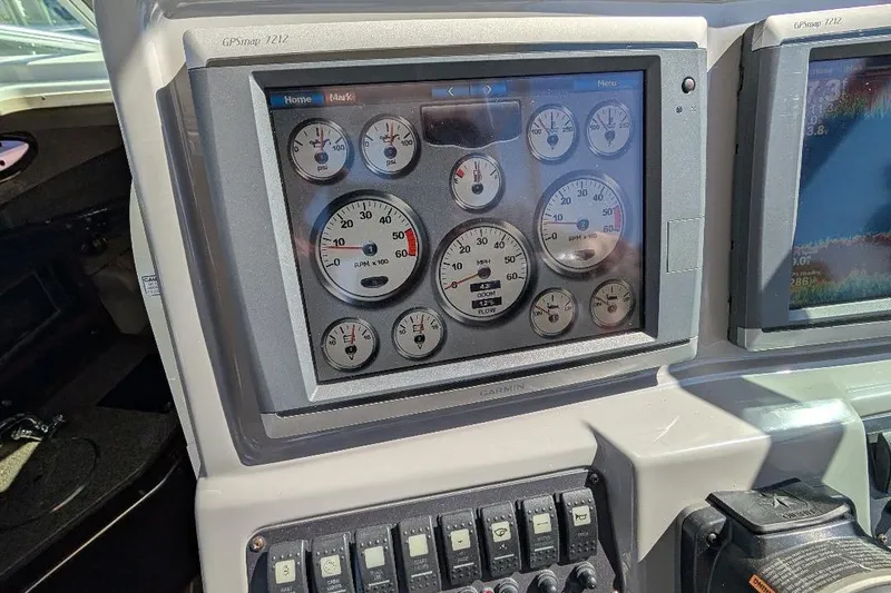 Slide: The Image of Dashboard of 2014 Robalo R305 Walkaround boat with gauges and controls. - 22