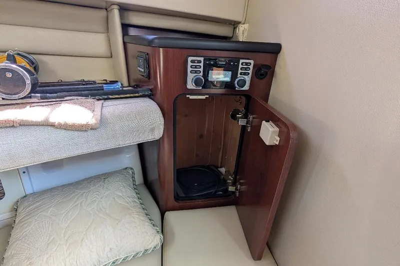 Slide: The Image of 2014 Robalo R305 Walkaround cabin interior with fishing gear and open storage compartment. - 28