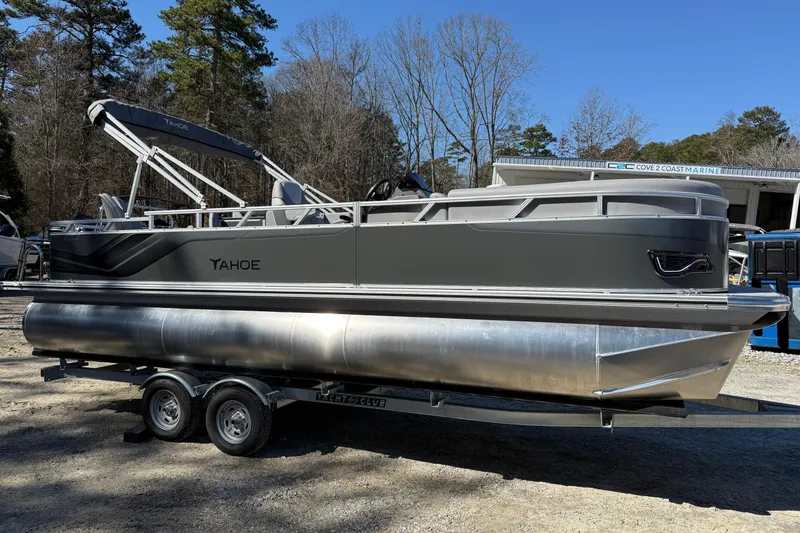 Slide: The Image of 2026 Tahoe Pontoon Sport 85 Rear Fish on trailer, parked outdoors. - 1