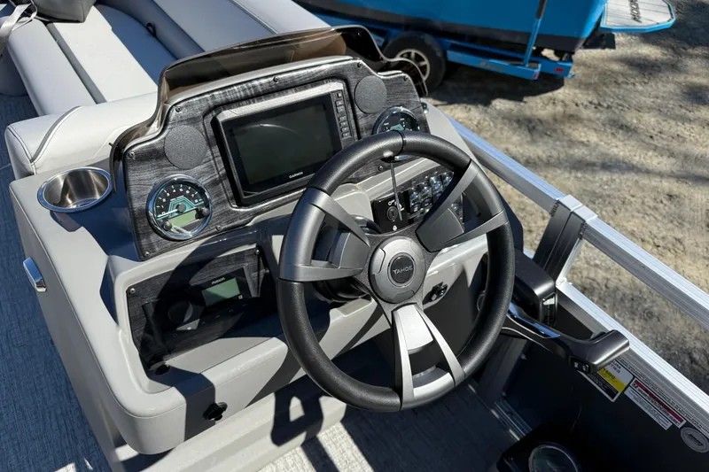 Slide: The Image of 2026 Tahoe Pontoon Sport 85 Rear Fish dashboard with steering wheel and controls. - 11