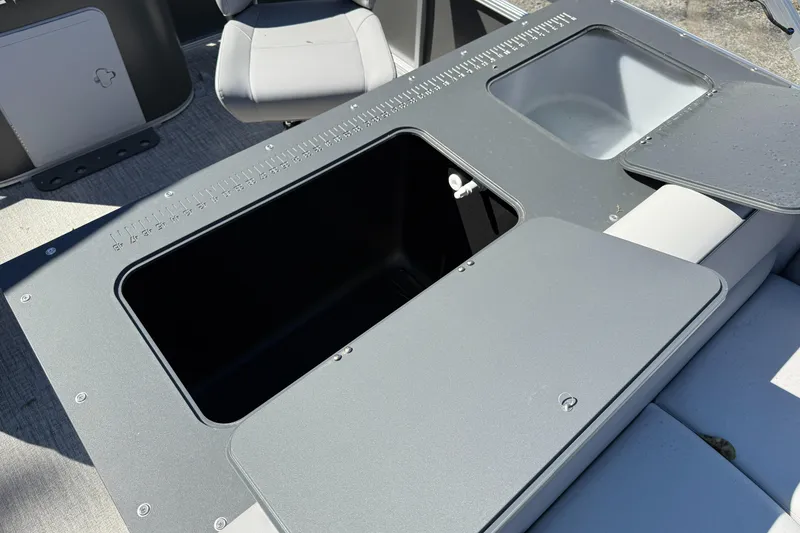 Slide: The Image of 2026 Tahoe Pontoon Sport 85 Rear Fish boat interior with storage compartments and seating. - 4