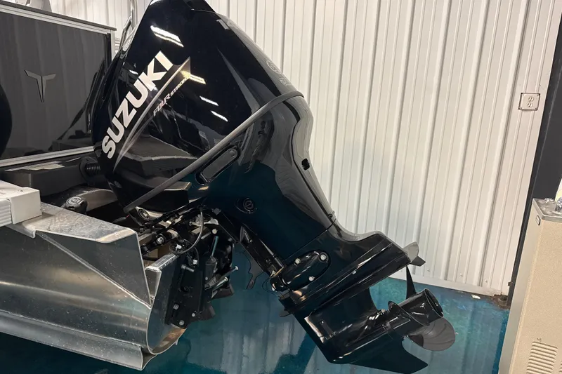 Slide: The Image of 2026 Tahoe Pontoon Sport 85 Rear Fish with Suzuki outboard motor in a showroom. - 11