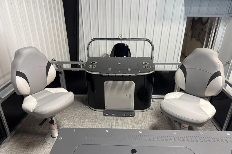 Slide: The Image of 2026 Tahoe Pontoon Sport 85 Rear Fish interior with two swivel seats and a control console. - 6