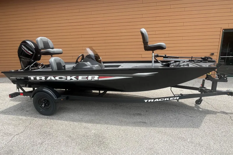 The Image of 2026 Tracker Pro 170 fishing boat on trailer, featuring Mercury outboard motor. - 0