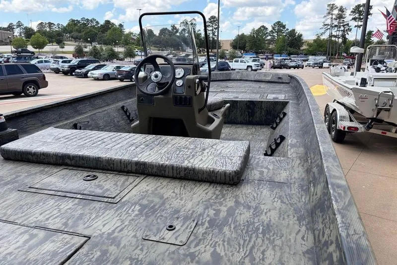 Slide: The Image of 2026 Tracker Grizzly 2072 CC boat with camouflage design, parked in a lot. - 4