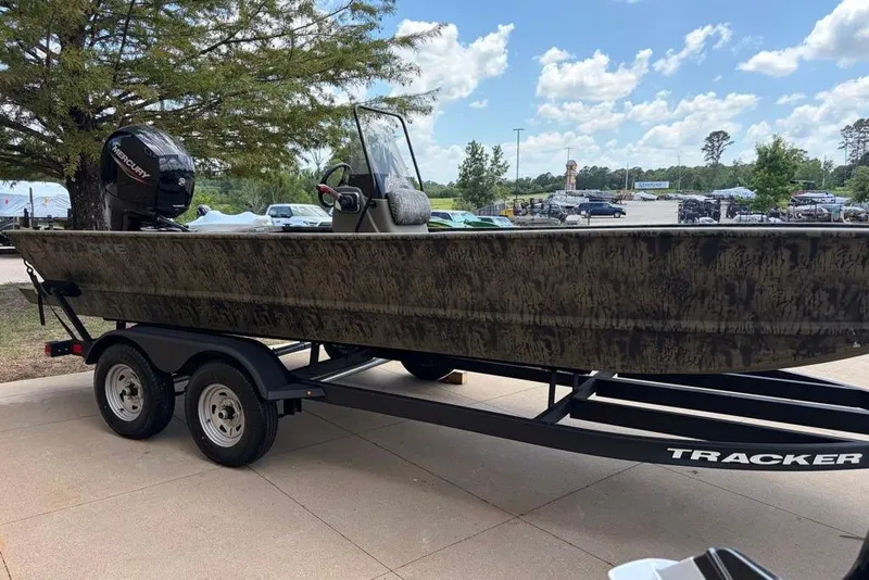 Slide: The Image of 2026 Tracker Grizzly 2072 CC boat on trailer, parked outdoors under a clear sky. - 2