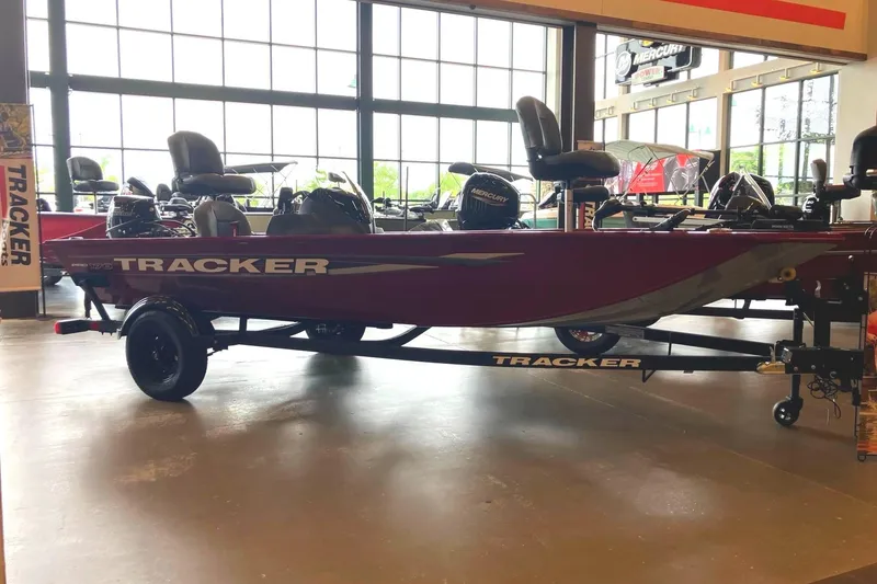 The Image of 2026 Tracker Pro 170 boat displayed indoors, featuring sleek design and modern seating. - 0