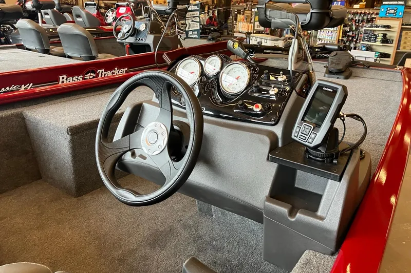Slide: The Image of 2026 Tracker Pro 170 boat dashboard with steering wheel and Garmin device. - 3