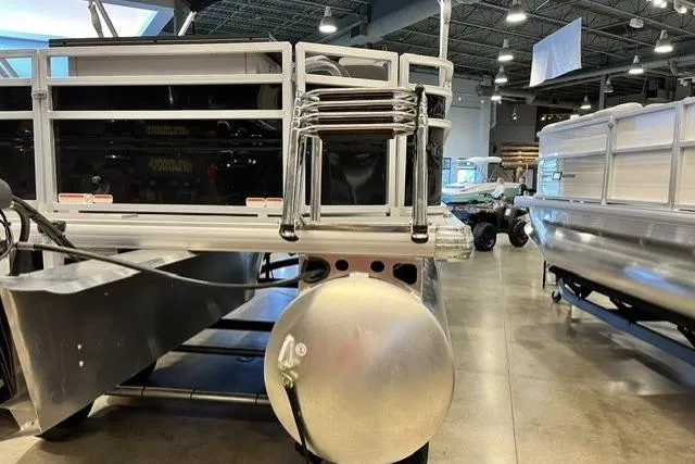 Slide: The Image of 2026 Sun Tracker SportFish 20 DLX pontoon boat in showroom, showcasing sleek design. - 97