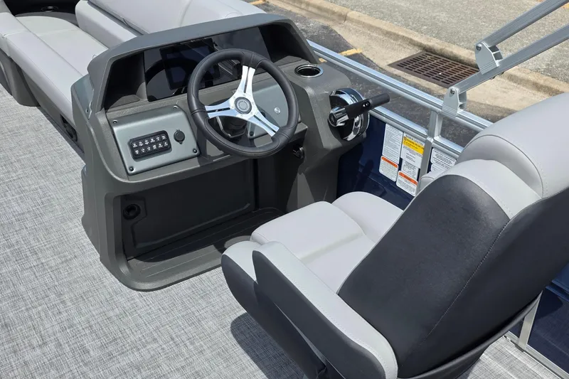 Slide: The Image of 2026 Sun Tracker SportFish 20 DLX boat interior with steering wheel and seating. - 3