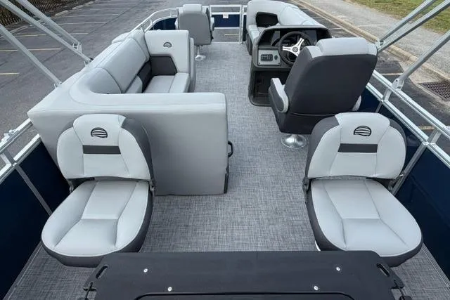 Slide: The Image of 2026 Sun Tracker SportFish 20 DLX pontoon boat interior with gray seating and steering console. - 7