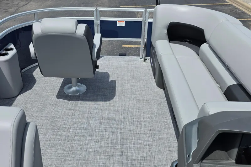 Slide: The Image of 2026 Sun Tracker SportFish 20 DLX pontoon boat interior with gray seating and flooring. - 2