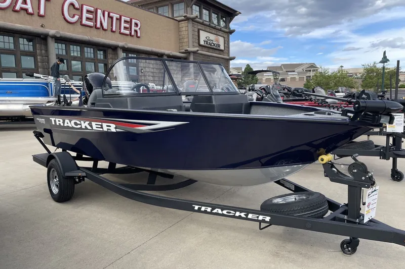The Image of 2026 Tracker Pro Guide V-175 WT boat displayed at dealership, blue exterior, on trailer. - 0