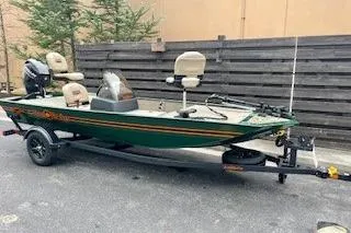 The Image of 2026 Tracker Bass Tracker Classic Limited fishing boat on trailer, parked outdoors. - 0