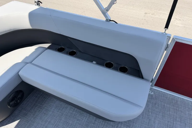 Slide: The Image of 2026 Sun Tracker Party Barge 16 DLX seating area with cup holders and gray upholstery. - 15