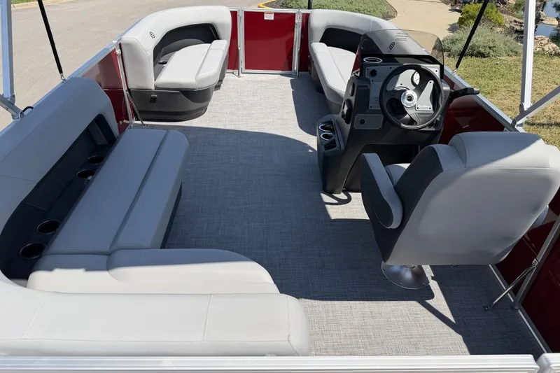 Slide: The Image of 2026 Sun Tracker Party Barge 16 DLX interior with spacious seating and modern helm. - 16