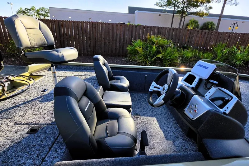 Slide: The Image of 2026 Tracker Pro Team 195 boat interior with steering console and seating. - 14