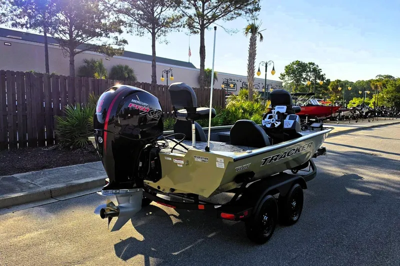 Slide: The Image of 2026 Tracker Pro Team 195 boat with Mercury Pro XS engine parked outdoors. - 3