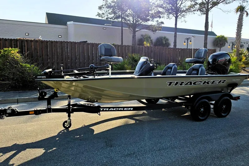 Slide: The Image of 2026 Tracker Pro Team 195 boat on trailer, parked outdoors in sunny setting. - 8