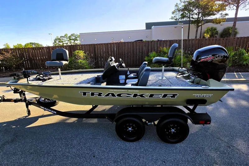 Slide: The Image of 2026 Tracker Pro Team 195 boat with Mercury engine, parked outdoors on a sunny day. - 12