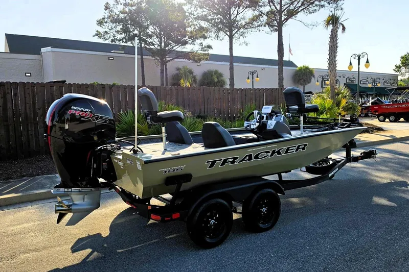 Slide: The Image of 2026 Tracker Pro Team 195 boat with Mercury engine, parked outdoors. - 2