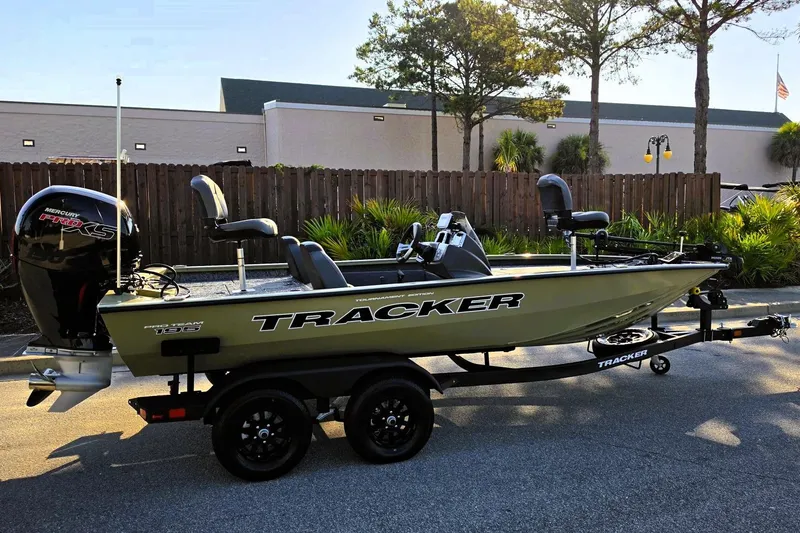 The Image of 2026 Tracker Pro Team 195 fishing boat on trailer, parked outdoors. - 0