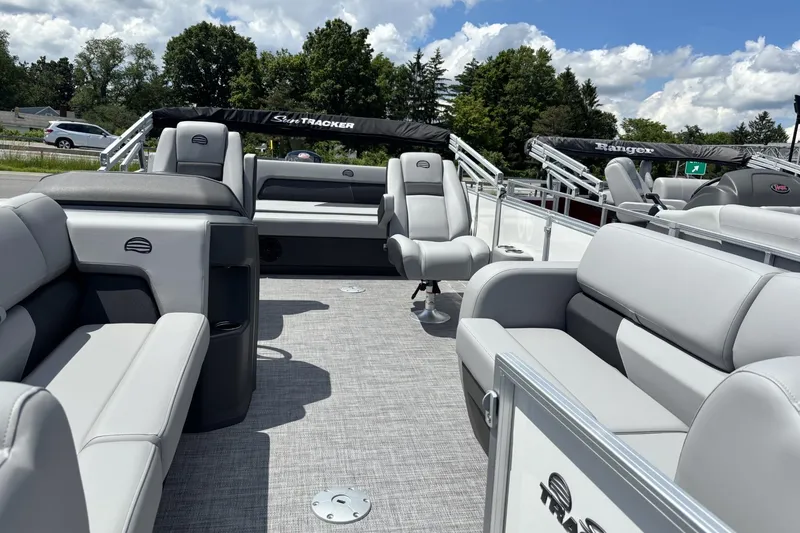 Slide: The Image of 2026 Sun Tracker Party Barge 22 RF DLX interior with plush seating and open deck. - 1