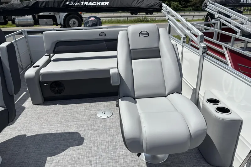 Slide: The Image of 2026 Sun Tracker Party Barge 22 RF DLX interior with gray seating and cup holders. - 2