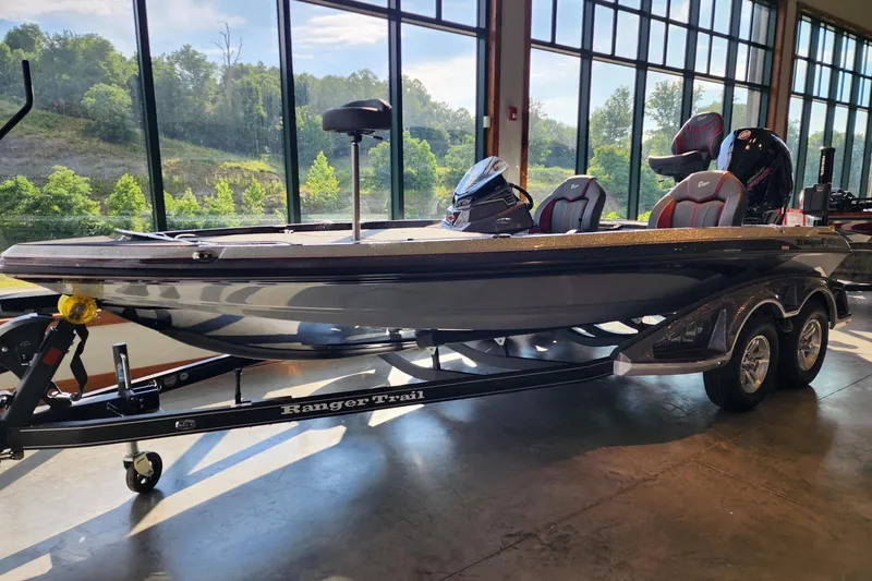 Slide: The Image of 2026 Ranger Z519R boat on trailer in showroom with scenic window view. - 1