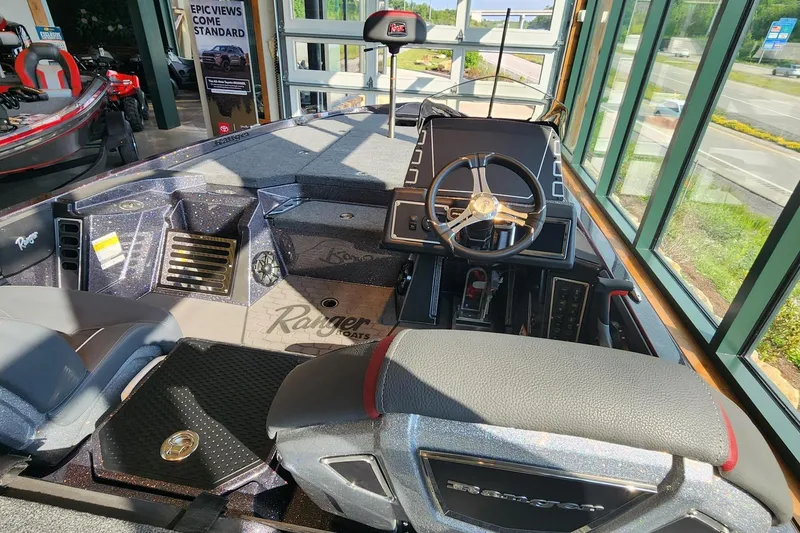 Slide: The Image of 2026 Ranger Z519R boat interior with steering wheel and dashboard in showroom. - 4