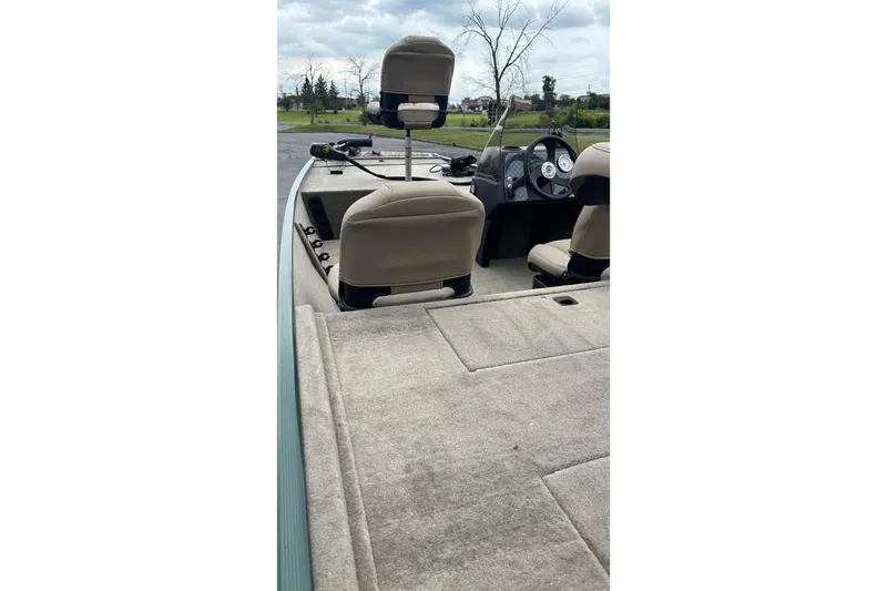 Slide: The Image of 2026 Tracker Bass Tracker Classic Limited boat interior with beige seats and dashboard. - 3