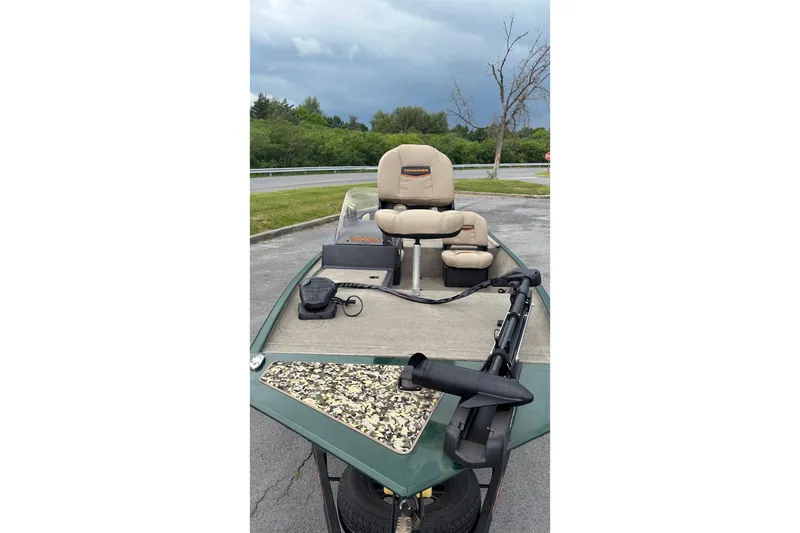 Slide: The Image of 2026 Tracker Bass Tracker Classic Limited boat with beige seats and trolling motor. - 4