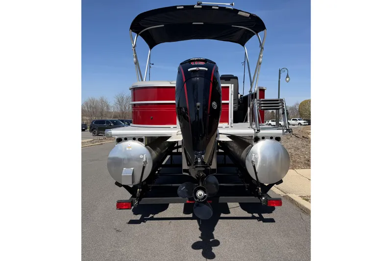 Slide: The Image of 2026 Sun Tracker Party Barge 20 DLX pontoon boat, rear view with motor and canopy. - 4
