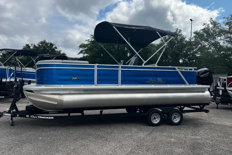 Slide: The Image of 2026 Sun Tracker Party Barge 22 RF DLX pontoon boat with canopy on trailer. - 3