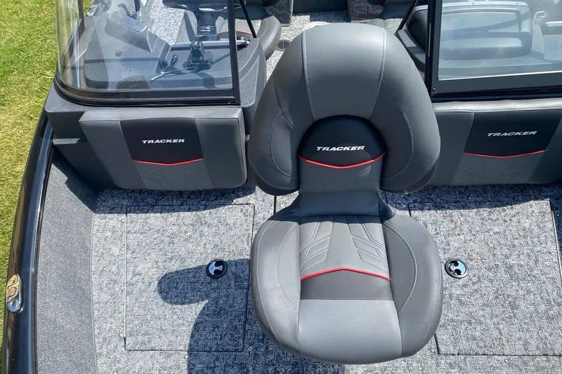 Slide: The Image of 2026 Tracker Pro Guide V-175 Combo boat interior with gray seating and red accents. - 8