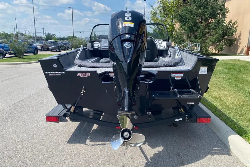 Slide: The Image of 2026 Tracker Pro Guide V-175 Combo boat with powerful outboard motor, parked outdoors. - 4