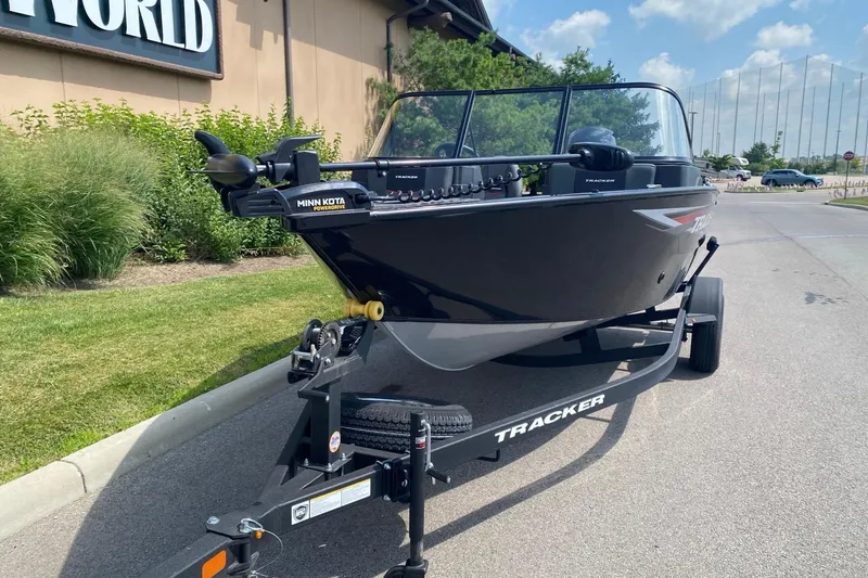 Slide: The Image of 2026 Tracker Pro Guide V-175 Combo boat on trailer, parked outdoors. - 3