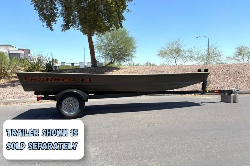 The Image of 2026 Tracker Grizzly 14 Jon boat on trailer, parked outdoors; trailer sold separately. - 0