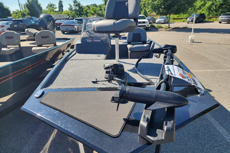 Slide: The Image of 2026 Tracker Bass Tracker Classic XL boat in parking lot, featuring seating and motor. - 2