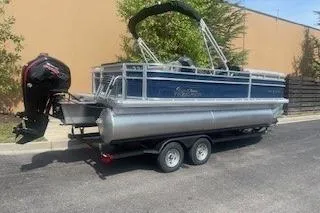 Slide: The Image of 2026 Sun Tracker SportFish 20 DLX pontoon boat on trailer, parked outdoors. - 3
