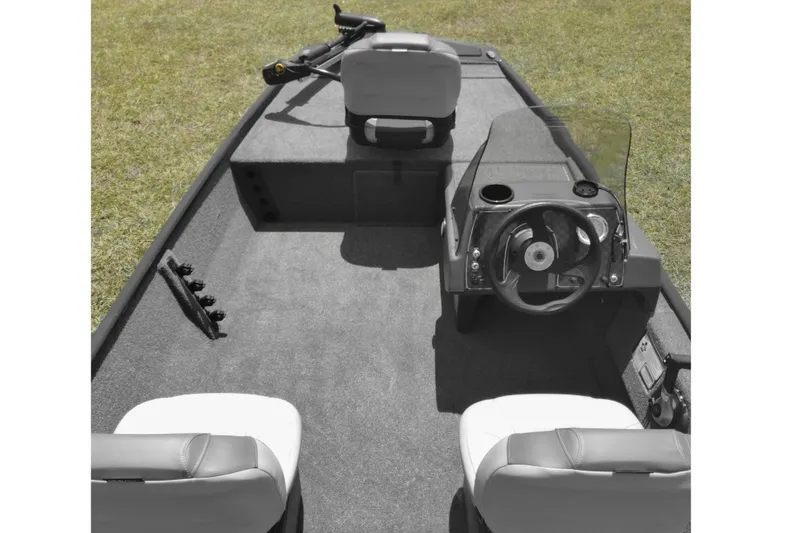 Slide: The Image of 2026 Tracker Bass Tracker Classic XL boat interior with steering wheel and seating on grass. - 10