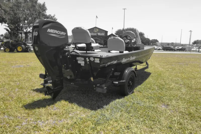 Slide: The Image of 2026 Tracker Bass Tracker Classic XL boat with Mercury engine on grassy field. - 4