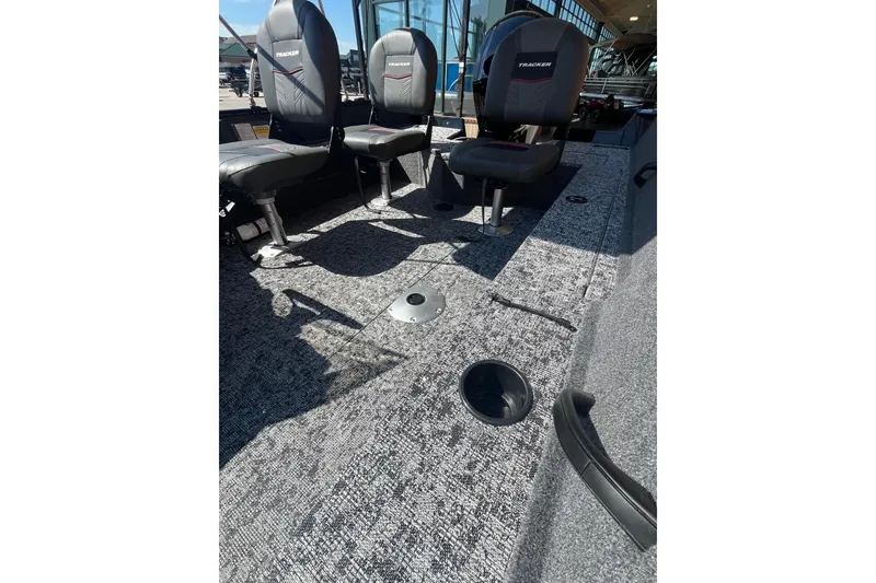 Slide: The Image of 2026 Tracker Pro Guide V-16 SC boat interior with seating and carpeted flooring. - 2