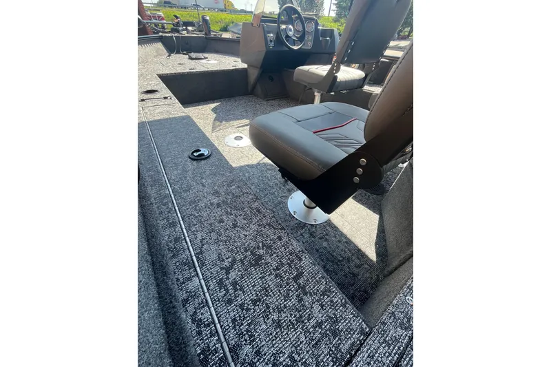 Slide: The Image of 2026 Tracker Pro Guide V-16 SC boat interior with seating and steering console. - 4