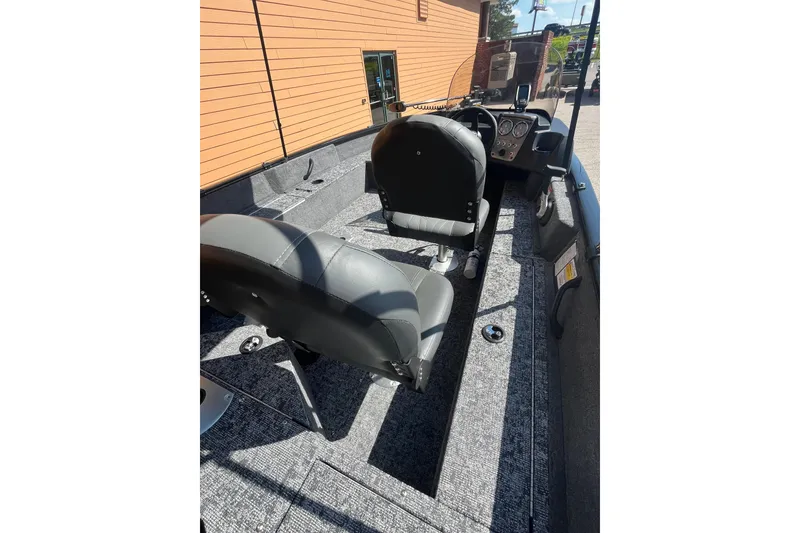 Slide: The Image of 2026 Tracker Pro Guide V-16 SC boat interior with seating and control panel. - 5