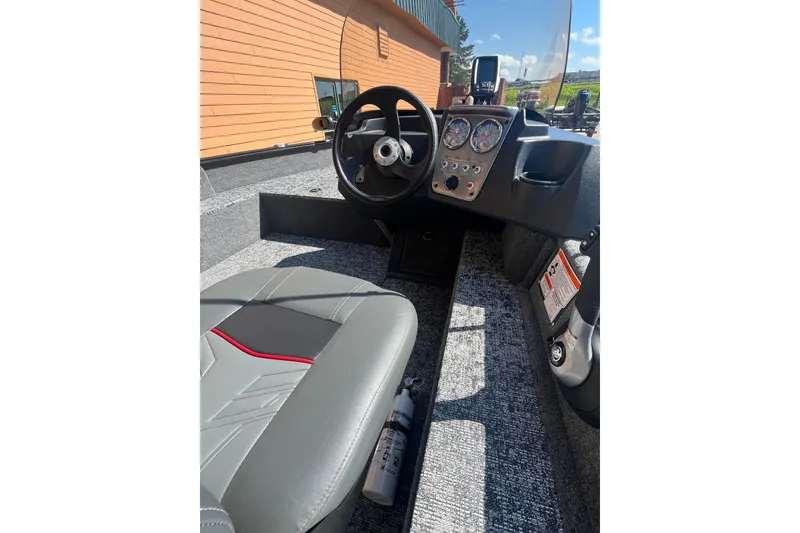 Slide: The Image of 2026 Tracker Pro Guide V-16 SC boat interior with steering wheel and dashboard controls. - 6