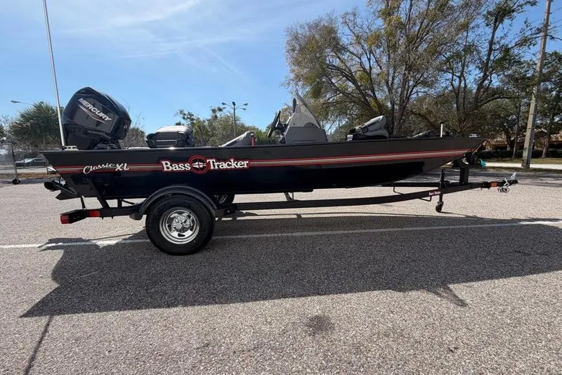 The Image of 2026 Tracker Bass Tracker Classic XL boat on trailer in parking lot. - 0
